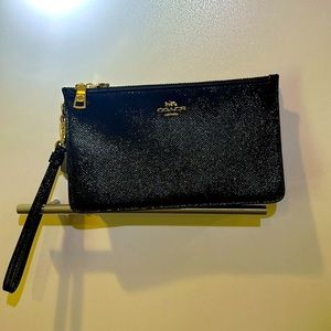 COACH signature textured black patent leather wristlet.